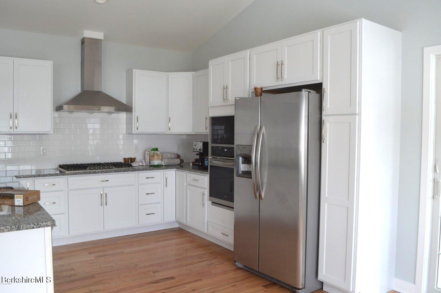 5 Aspen Way Pittsfield, MA 01201 - Photo 10 of 19 a kitchen with stainless steel appliances granite countertop a refrigerator and a stove top oven