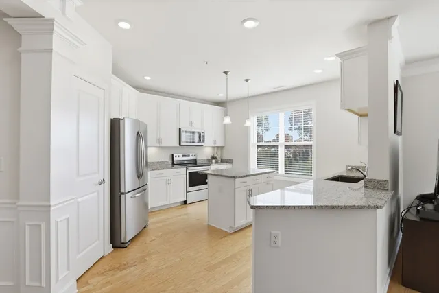 a kitchen with refrigerator and cabinets