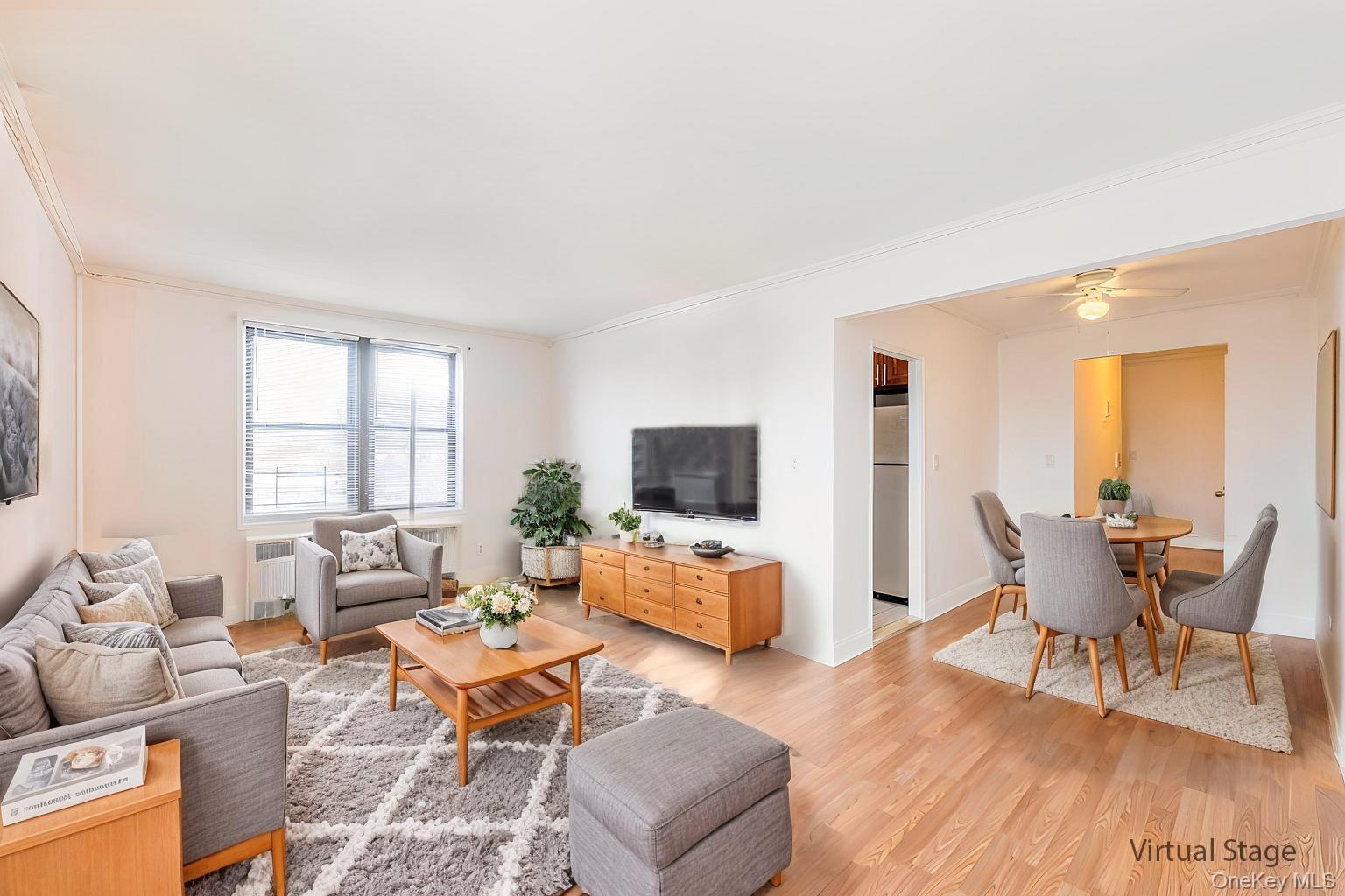 a living room with furniture wooden floor and a flat screen tv