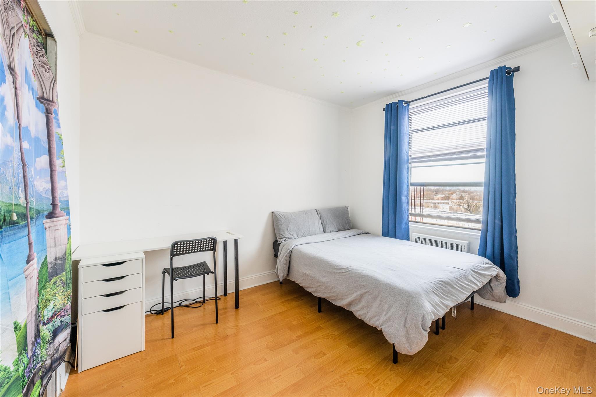 150-15 72nd Road, Unit 5G Queens, NY 11367 - Photo 12 of 27 a bedroom with a bed table and chair