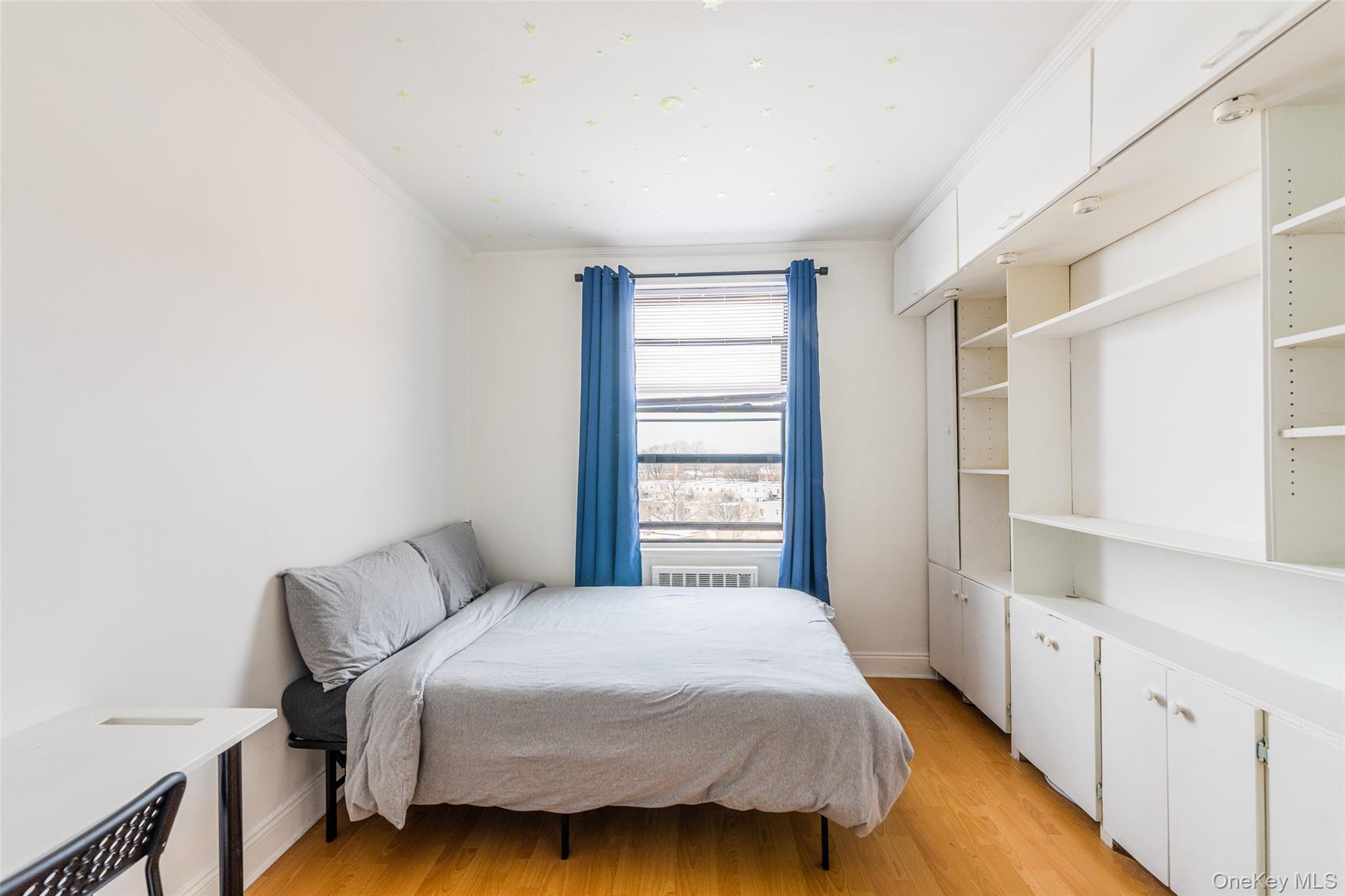 150-15 72nd Road, Unit 5G Queens, NY 11367 - Photo 13 of 27 a bedroom with a bed and a window