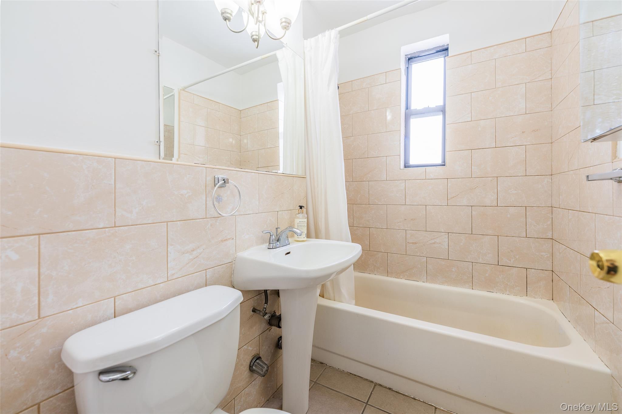 150-15 72nd Road, Unit 5G Queens, NY 11367 - Photo 14 of 27 a bathroom with a sink a toilet and bathtub