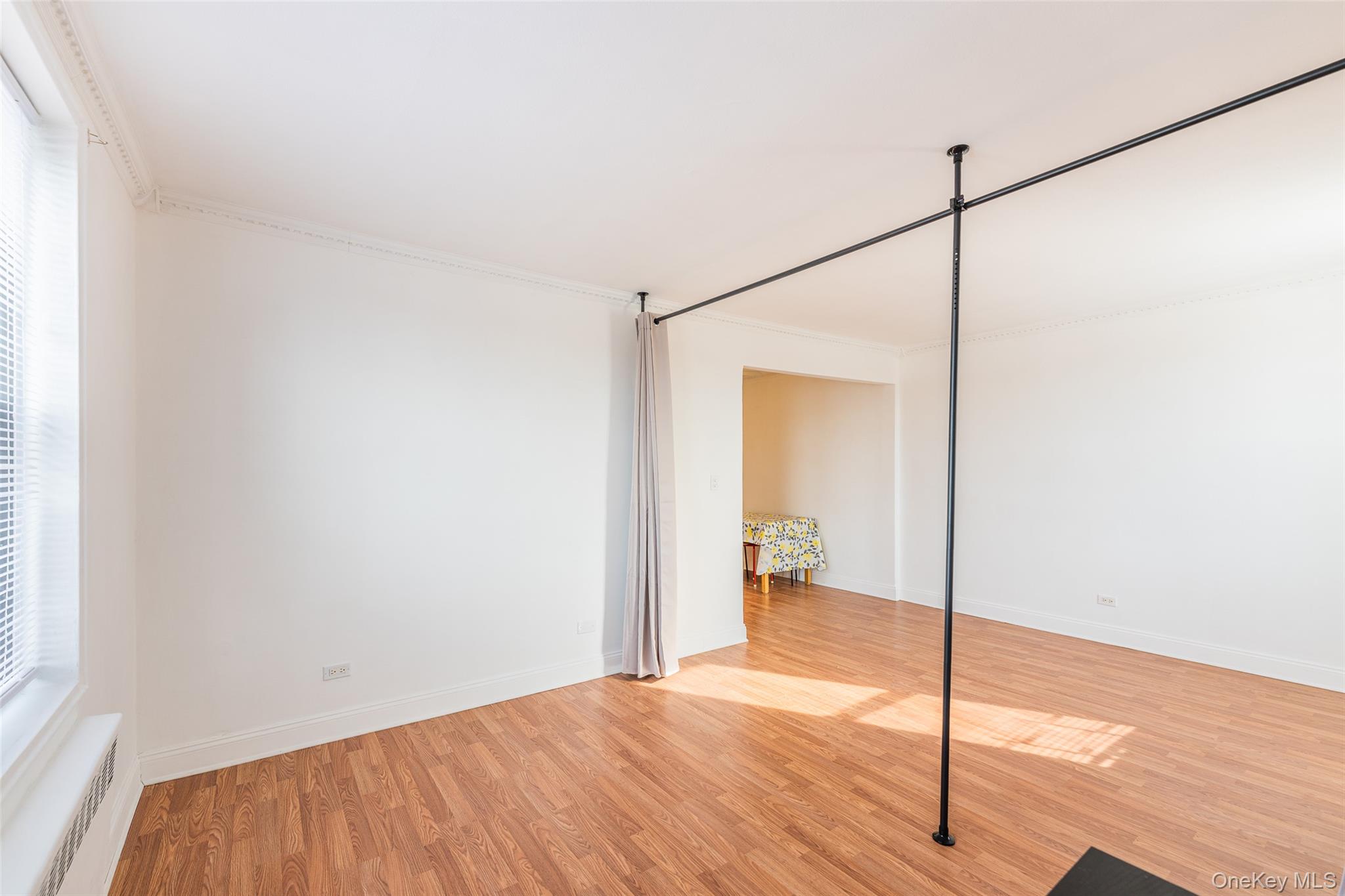 150-15 72nd Road, Unit 5G Queens, NY 11367 - Photo 4 of 27 a view of a room with wooden floor and a bathroom