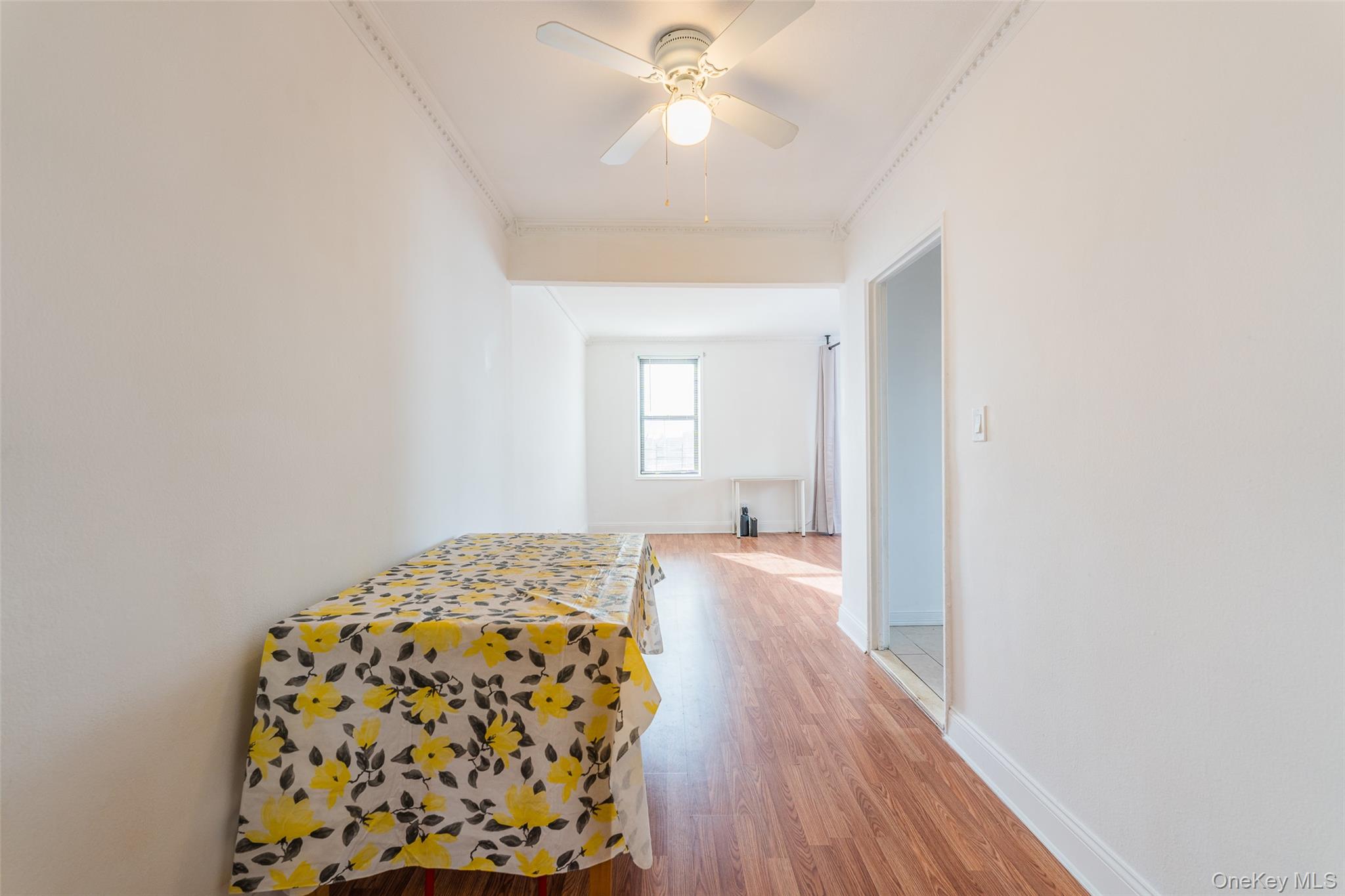 150-15 72nd Road, Unit 5G Queens, NY 11367 - Photo 5 of 27 a bedroom with a bed and a chandelier