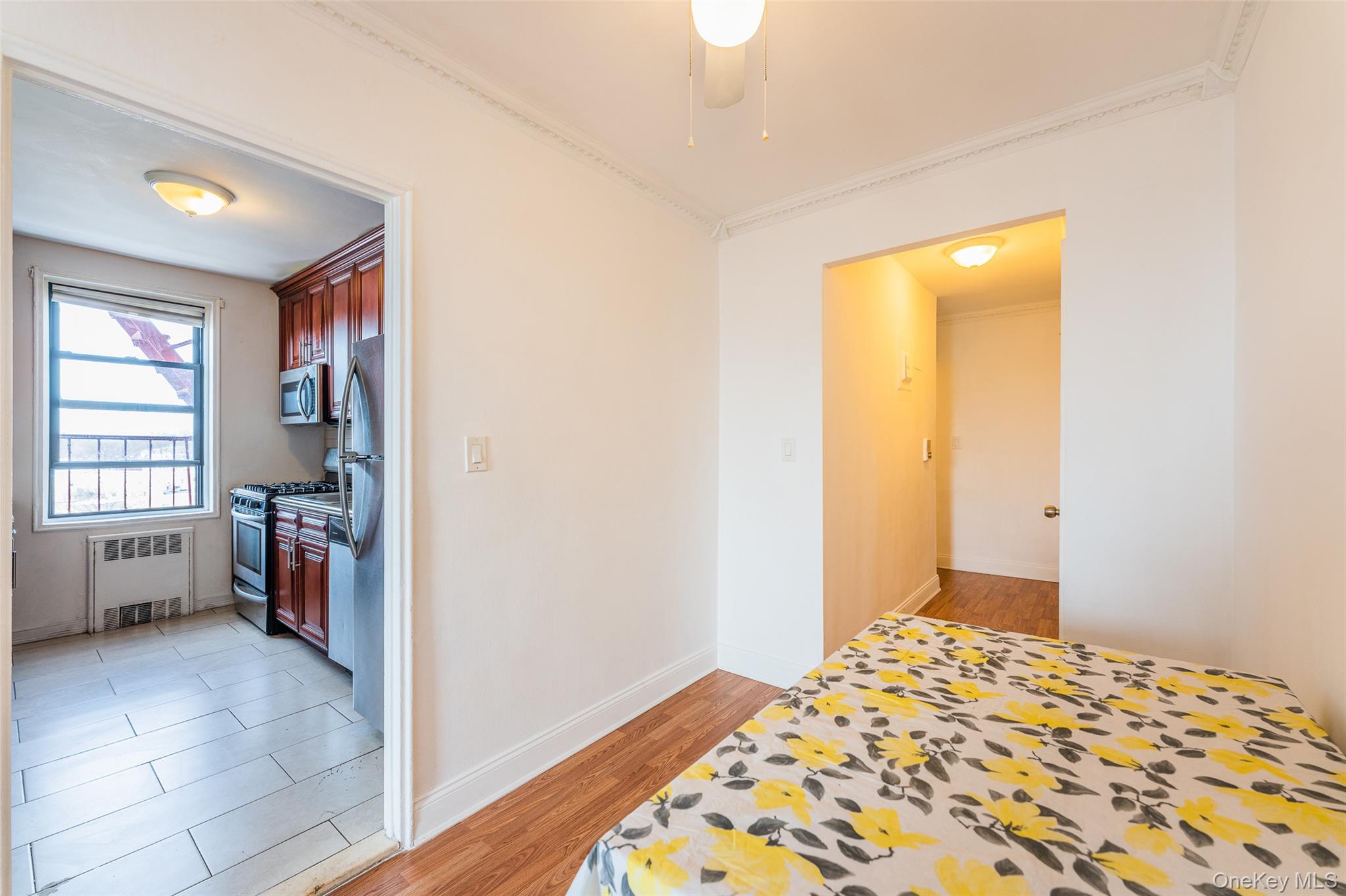 150-15 72nd Road, Unit 5G Queens, NY 11367 - Photo 8 of 27 a bedroom with a bed and a window