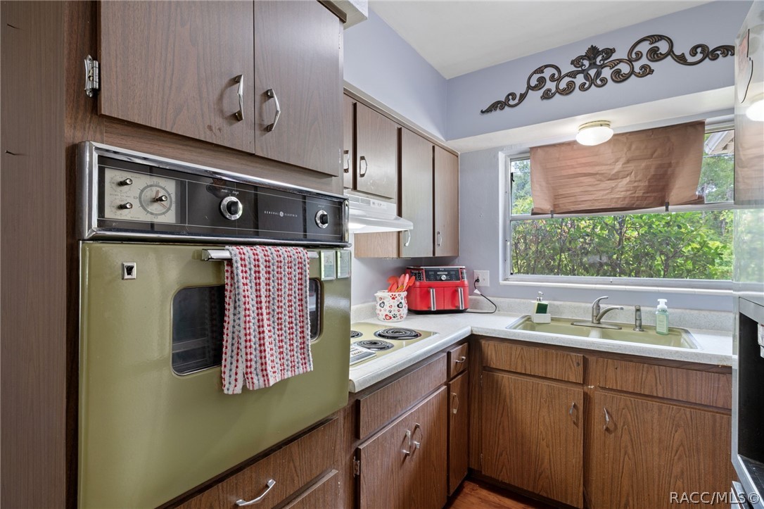 3355 South Highlands Avenue Inverness, FL 34452 - Photo 13 of 30 a kitchen with stainless steel appliances a sink a stove and a window