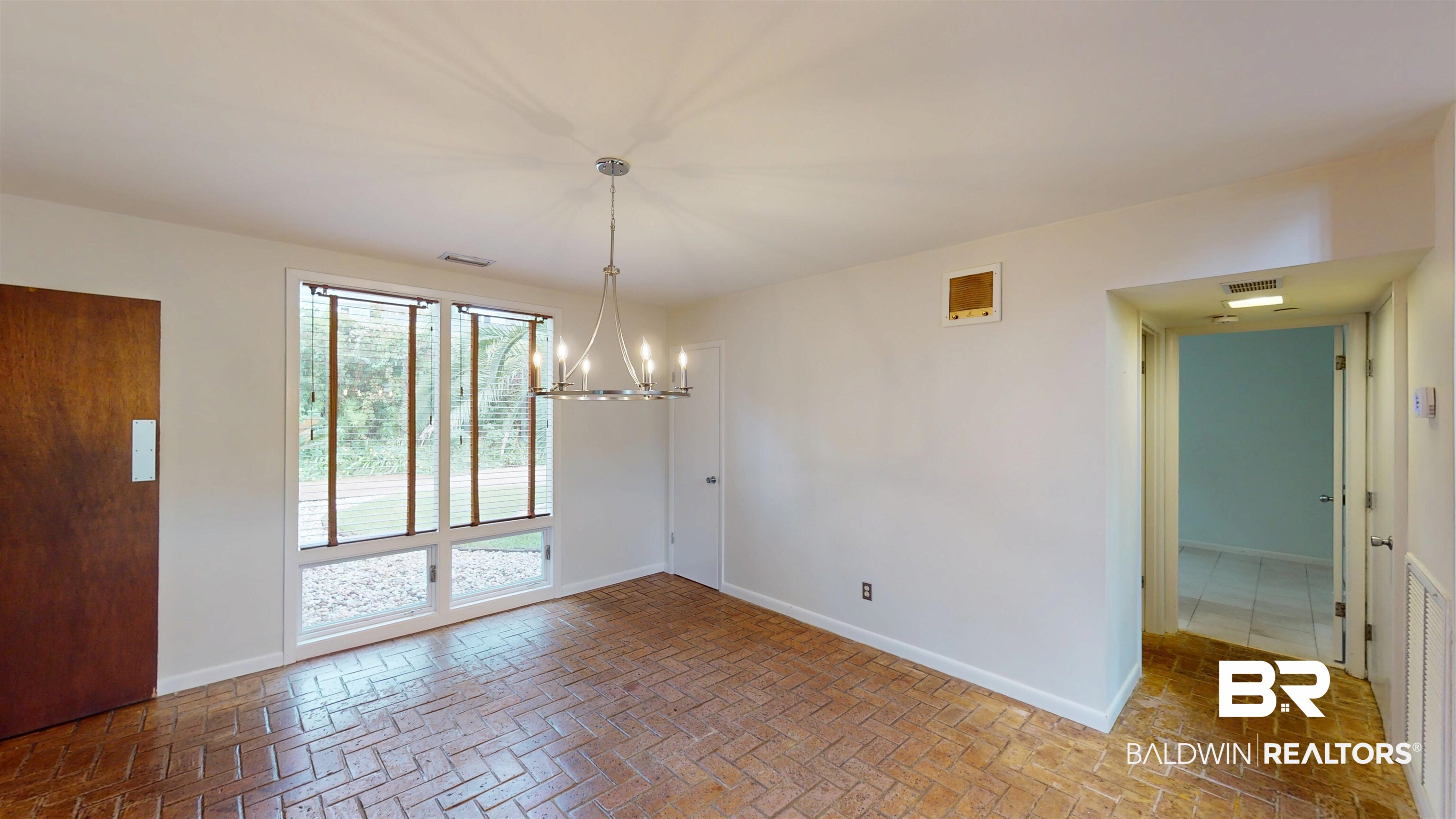 15 Spring Bank Road Mobile, AL 36608 - Photo 16 of 58 Unfurnished dining area featuring a chandelier and brick floors