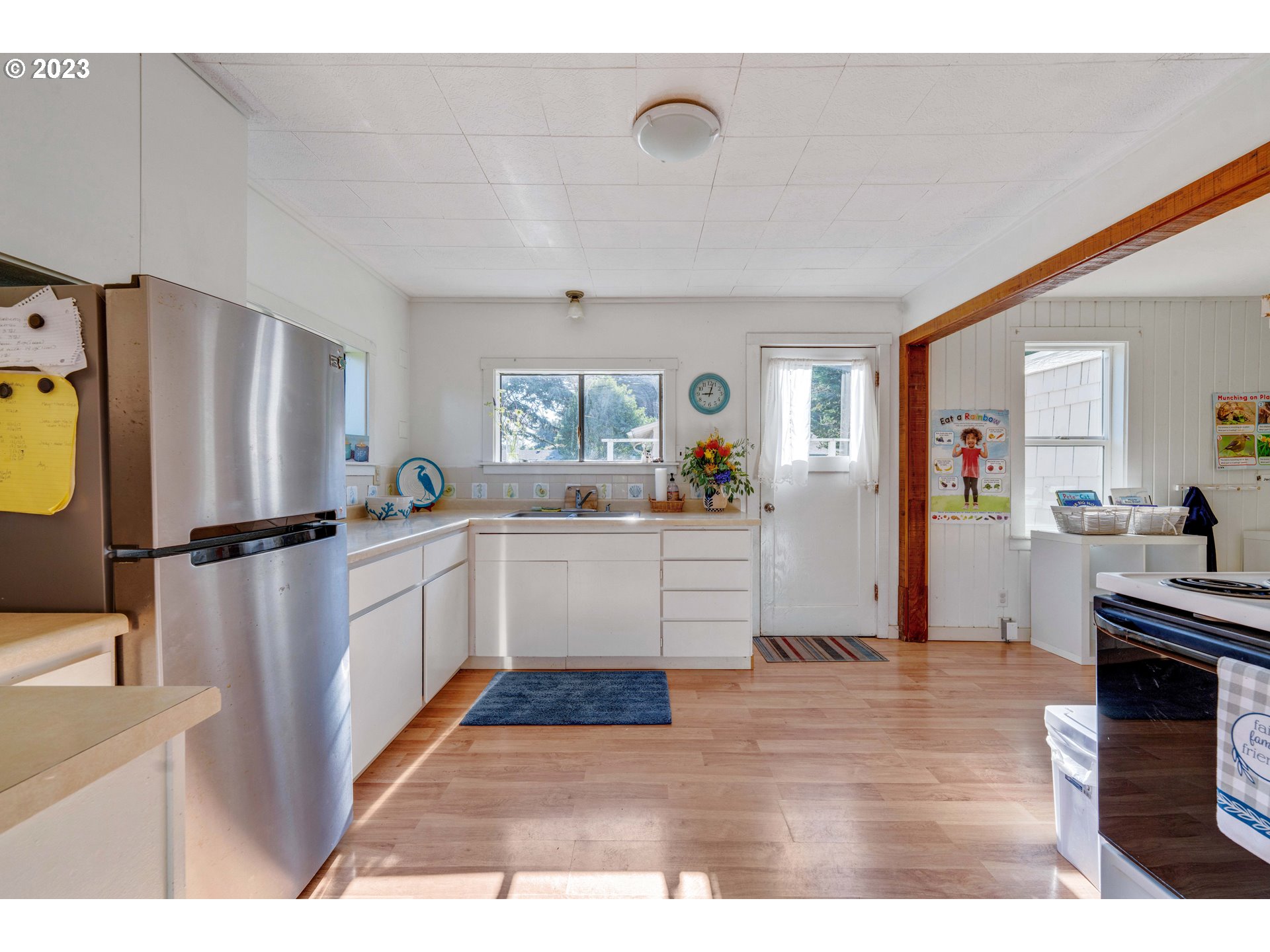535 Edison Avenue Southwest Bandon, OR 97411 - Photo 11 of 33 a kitchen with stainless steel appliances kitchen island granite countertop a refrigerator and a stove