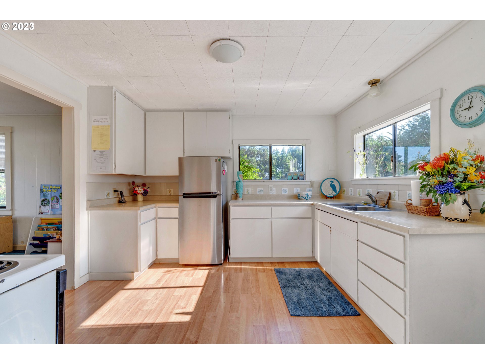 535 Edison Avenue Southwest Bandon, OR 97411 - Photo 12 of 33 a open kitchen with granite countertop a stove top oven sink and cabinets