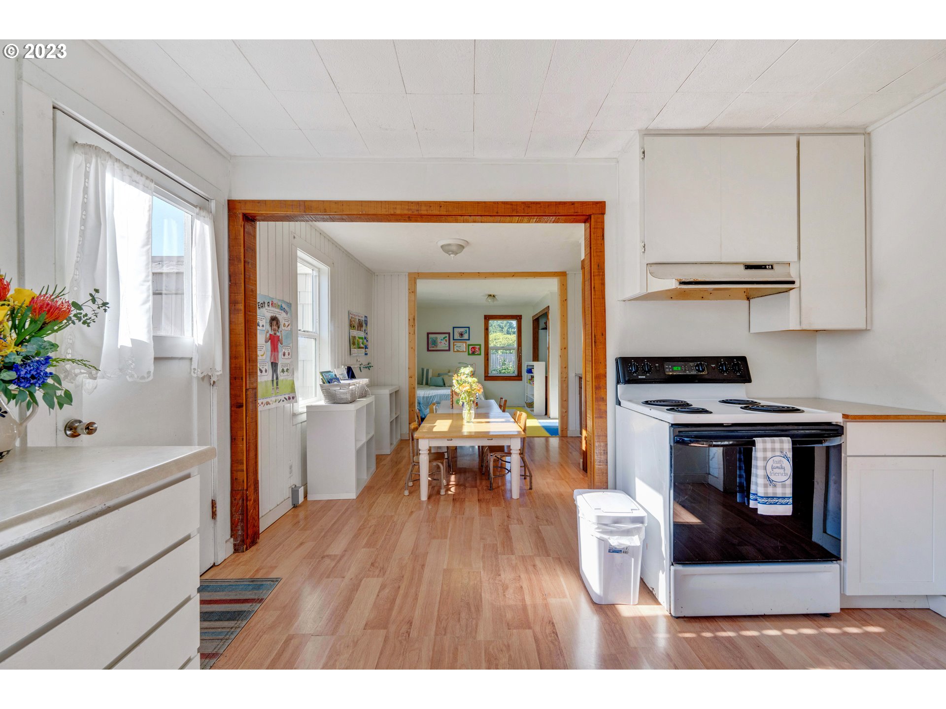 535 Edison Avenue Southwest Bandon, OR 97411 - Photo 13 of 33 a living room with stainless steel appliances furniture a rug and a kitchen view