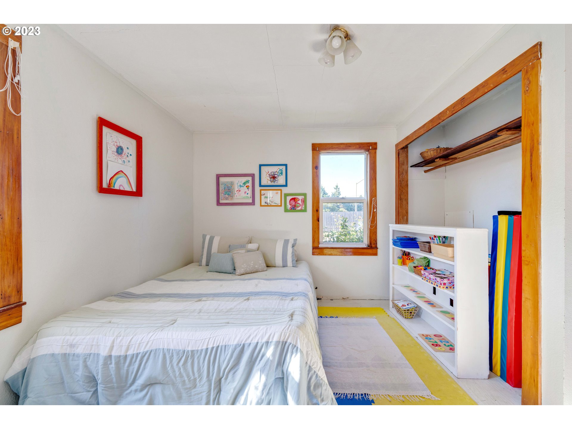 535 Edison Avenue Southwest Bandon, OR 97411 - Photo 16 of 33 a bedroom with a bed and a large window