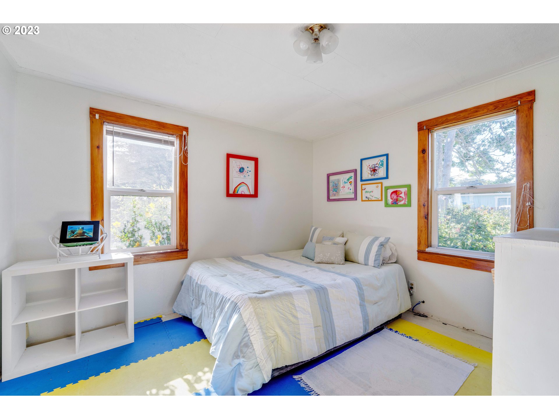 535 Edison Avenue Southwest Bandon, OR 97411 - Photo 17 of 33 a bedroom with a bed and a window