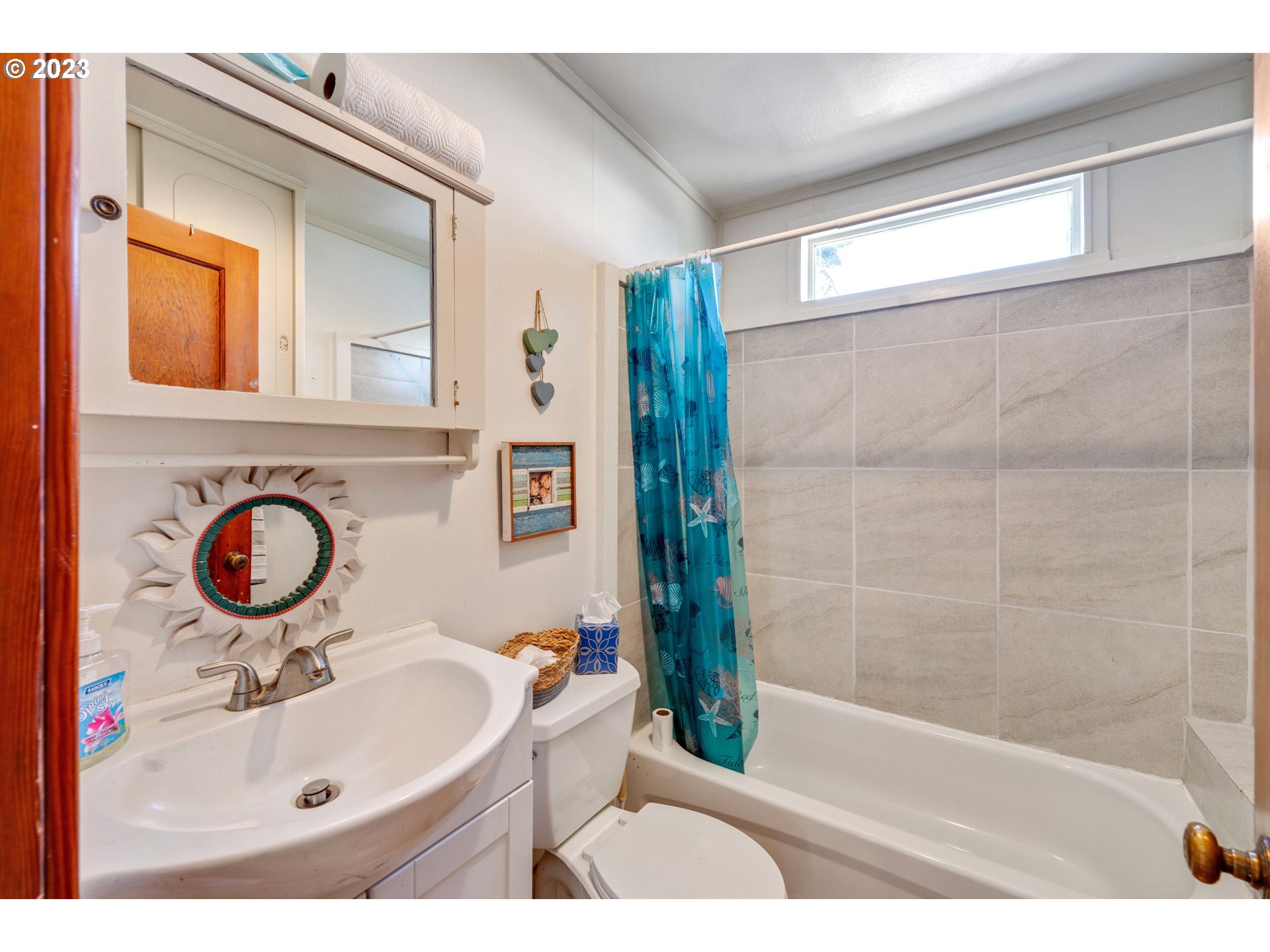 535 Edison Avenue Southwest Bandon, OR 97411 - Photo 19 of 33 a bathroom with a sink and a mirror