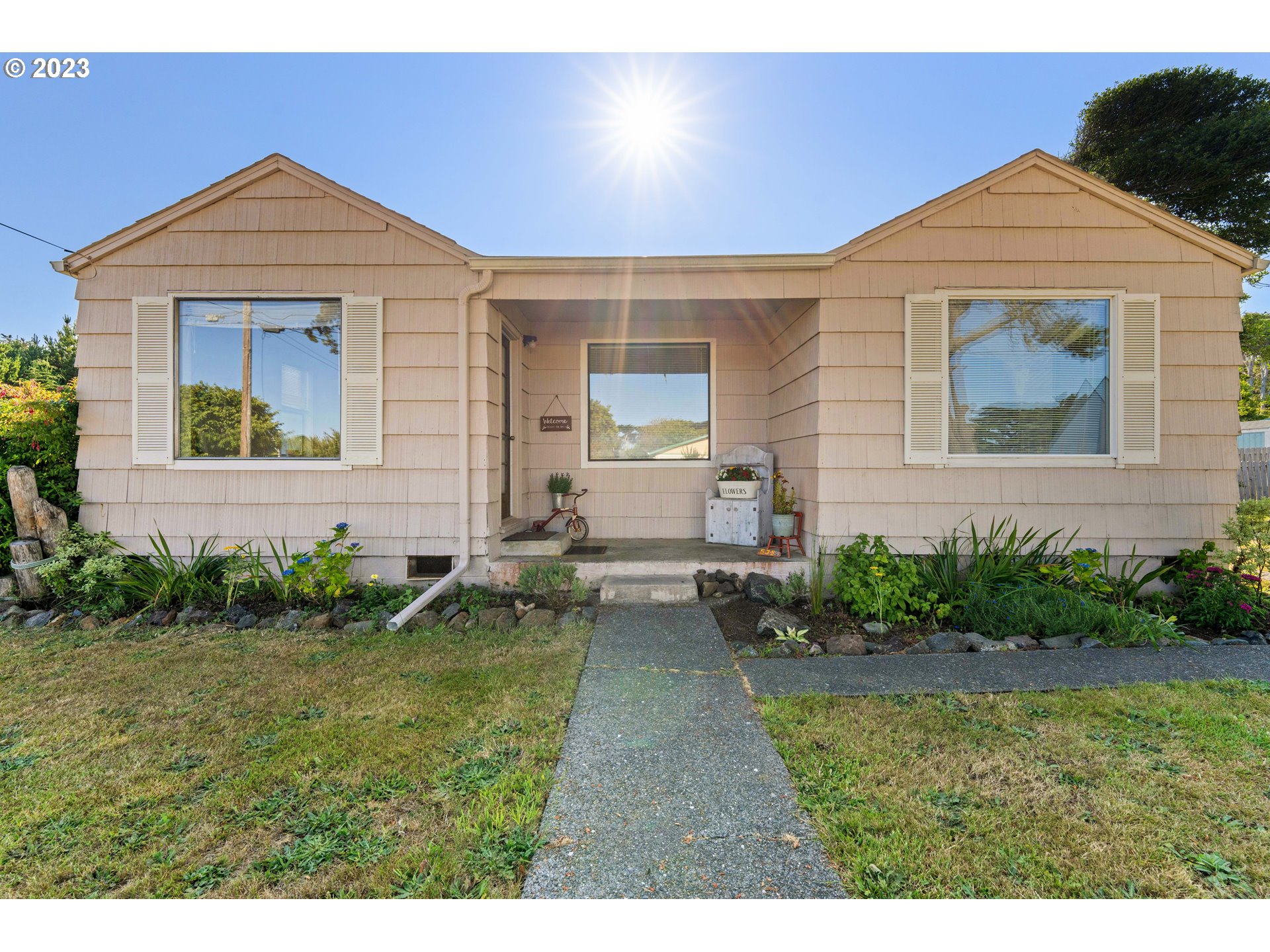 535 Edison Avenue Southwest Bandon, OR 97411 - Photo 3 of 33 a front view of a house with garden