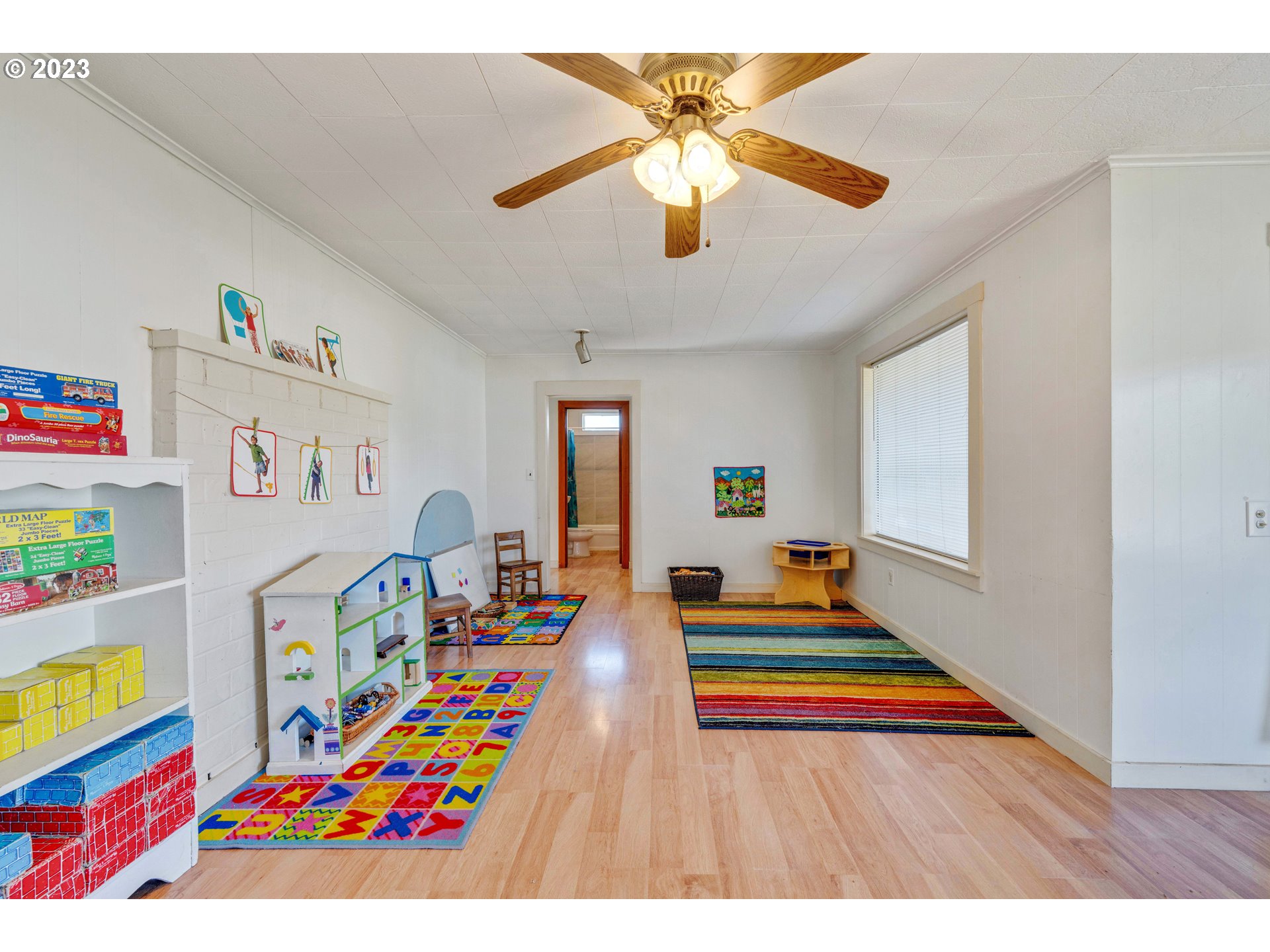 535 Edison Avenue Southwest Bandon, OR 97411 - Photo 6 of 33 a bedroom with a bed and a chandelier