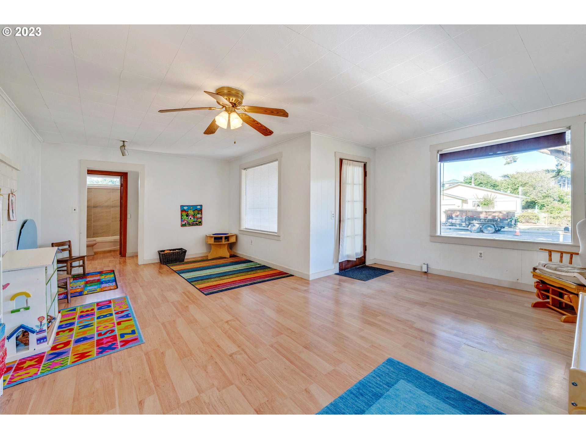 535 Edison Avenue Southwest Bandon, OR 97411 - Photo 10 of 33 a bedroom with furniture and a wooden floor