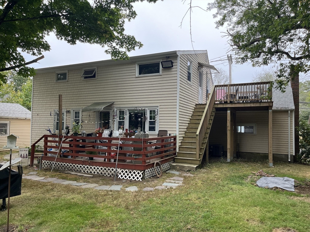 240 Spring Street Hanson, MA 02341 - Photo 5 of 20 a view of a house with a barbeque grill and a fireplace