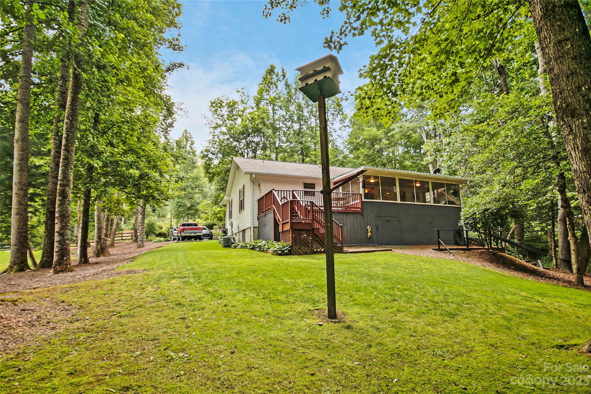 4211 Staton Road Hendersonville, NC 28739 - Photo 15 of 43 a front view of a house with a yard garage and tree