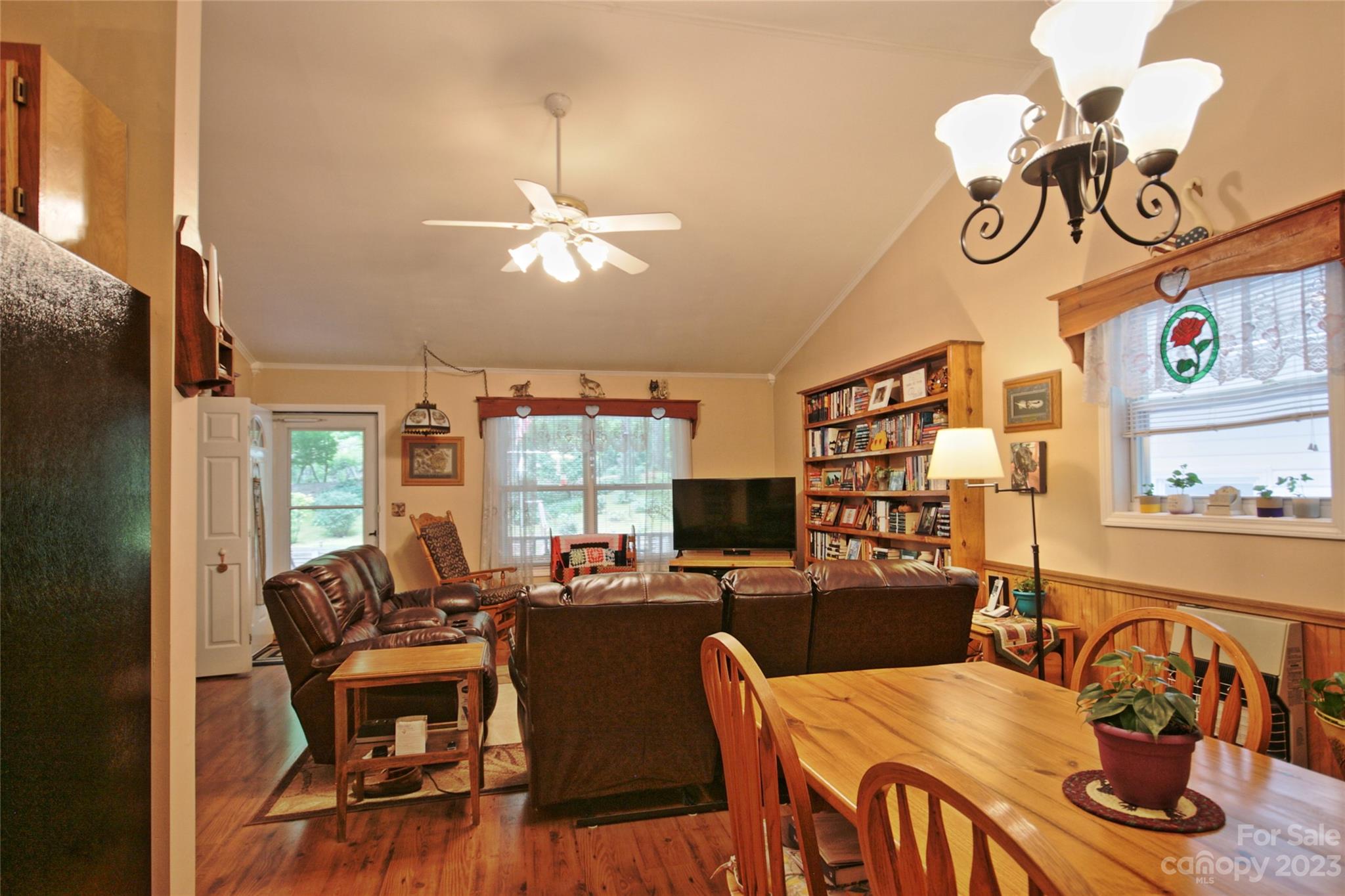 4211 Staton Road Hendersonville, NC 28739 - Photo 3 of 43 a view of a dining room with furniture a chandelier and wooden floor