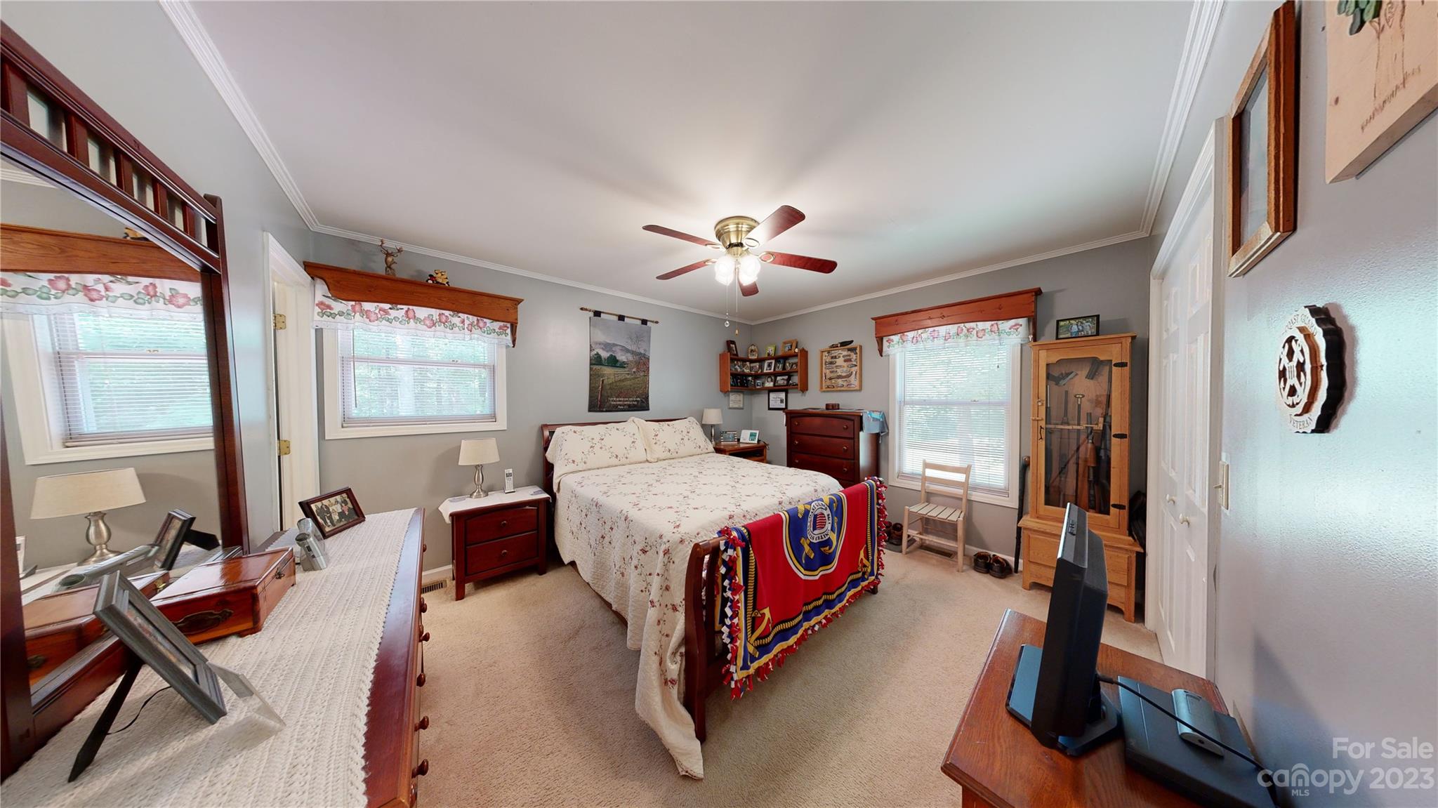 4211 Staton Road Hendersonville, NC 28739 - Photo 34 of 43 a very nice looking bedroom with a large bed and a chandelier