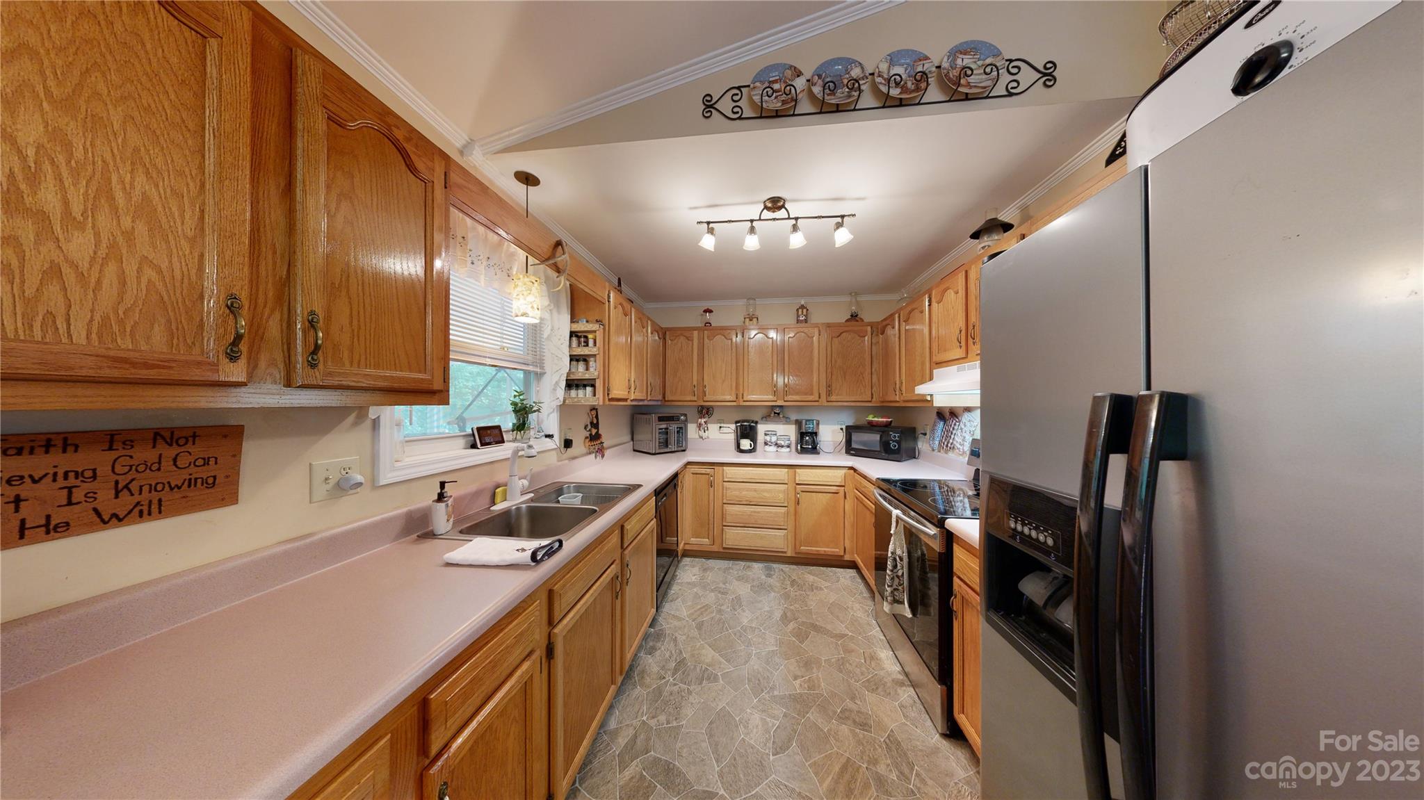 4211 Staton Road Hendersonville, NC 28739 - Photo 35 of 43 a kitchen with a sink a counter top space stainless steel appliances and a window