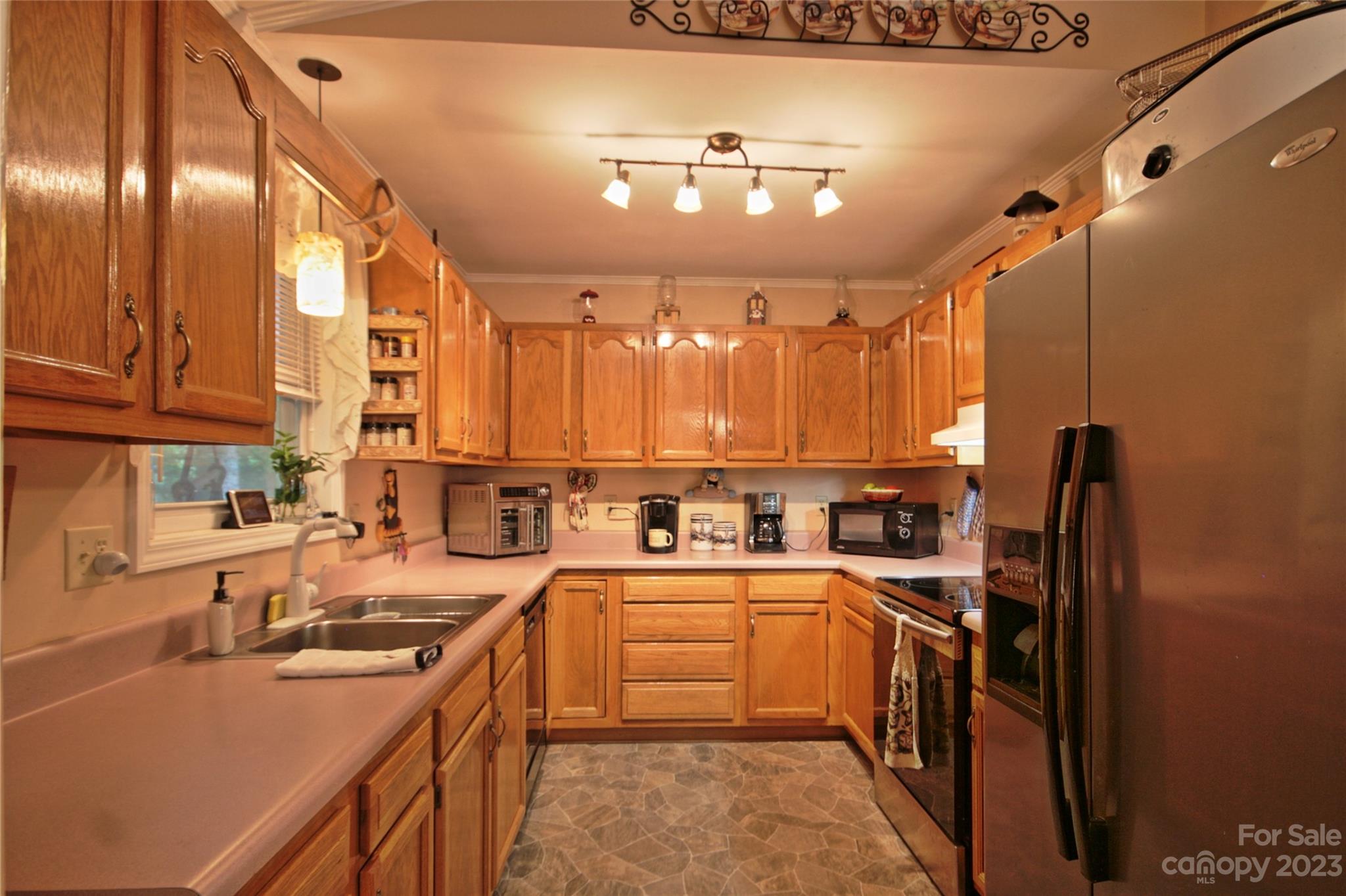 4211 Staton Road Hendersonville, NC 28739 - Photo 4 of 43 a kitchen with lots of counter space a sink and appliances