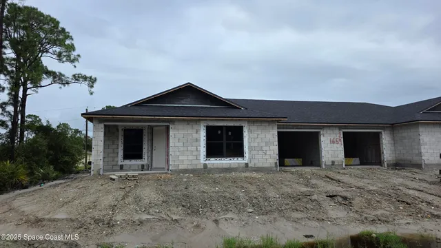 a view of a house with a yard and garage