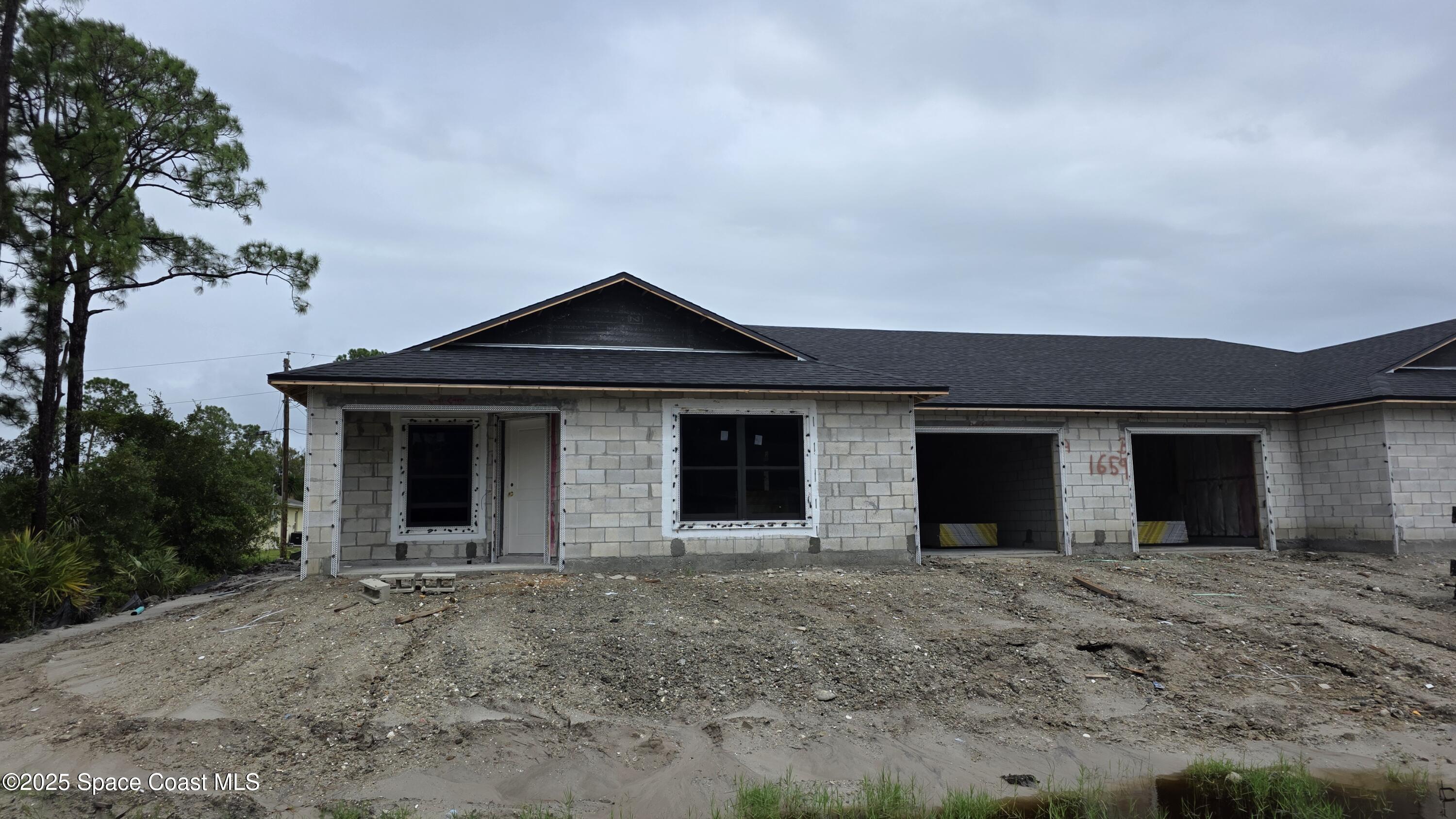 a view of a house with a yard and garage