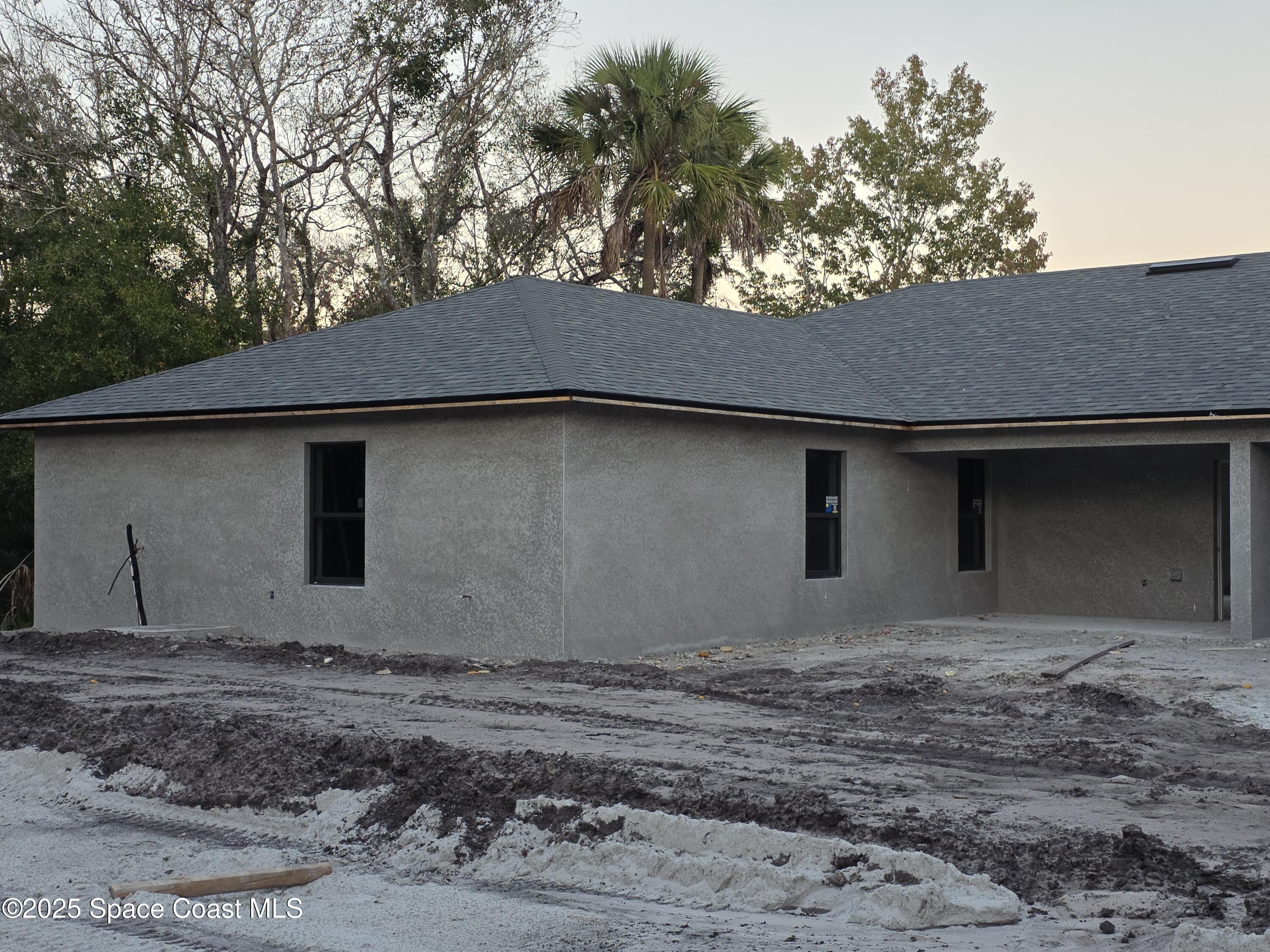 2542 Hester Avenue Southeast, Unit A Palm Bay, FL 32909 - Photo 7 of 9 a backyard of house with a garage
