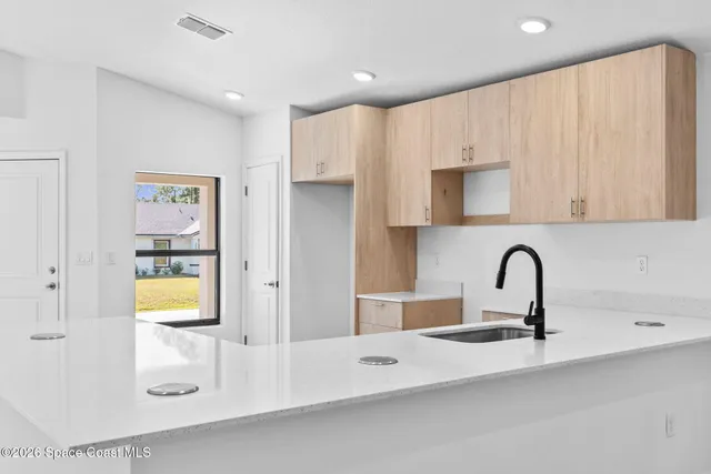 a kitchen with stainless steel appliances a sink a stove and a refrigerator