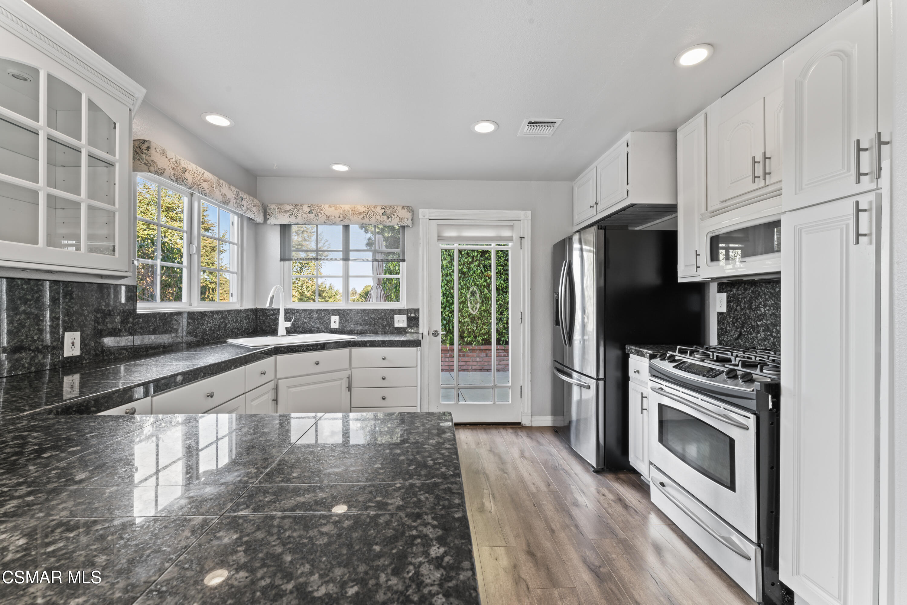 636 Sinaloa Road Simi Valley, CA 93065 - Photo 15 of 31 a large kitchen with cabinets a counter space stainless steel appliances and a window