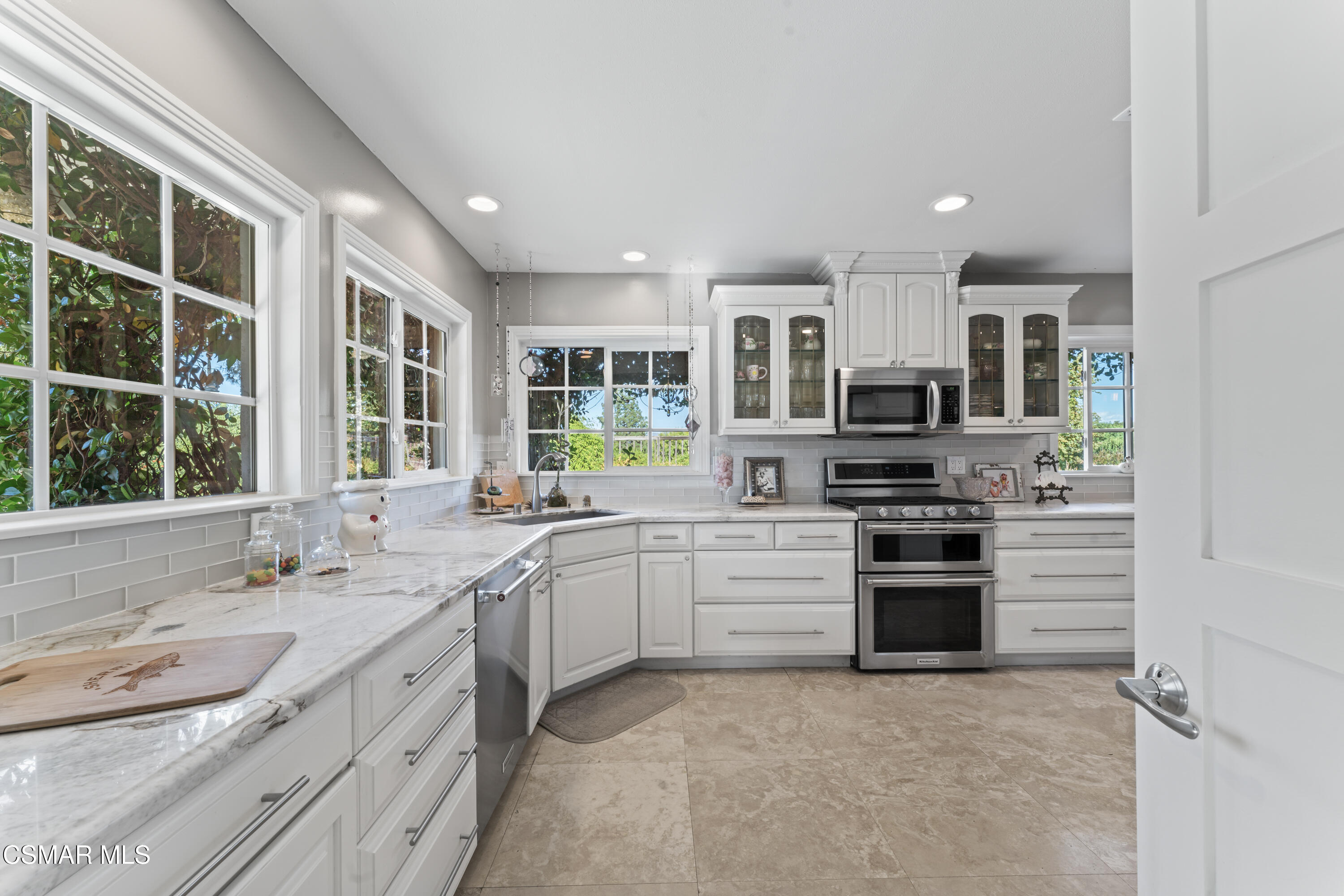636 Sinaloa Road Simi Valley, CA 93065 - Photo 4 of 31 a kitchen with stainless steel appliances granite countertop a sink and stove