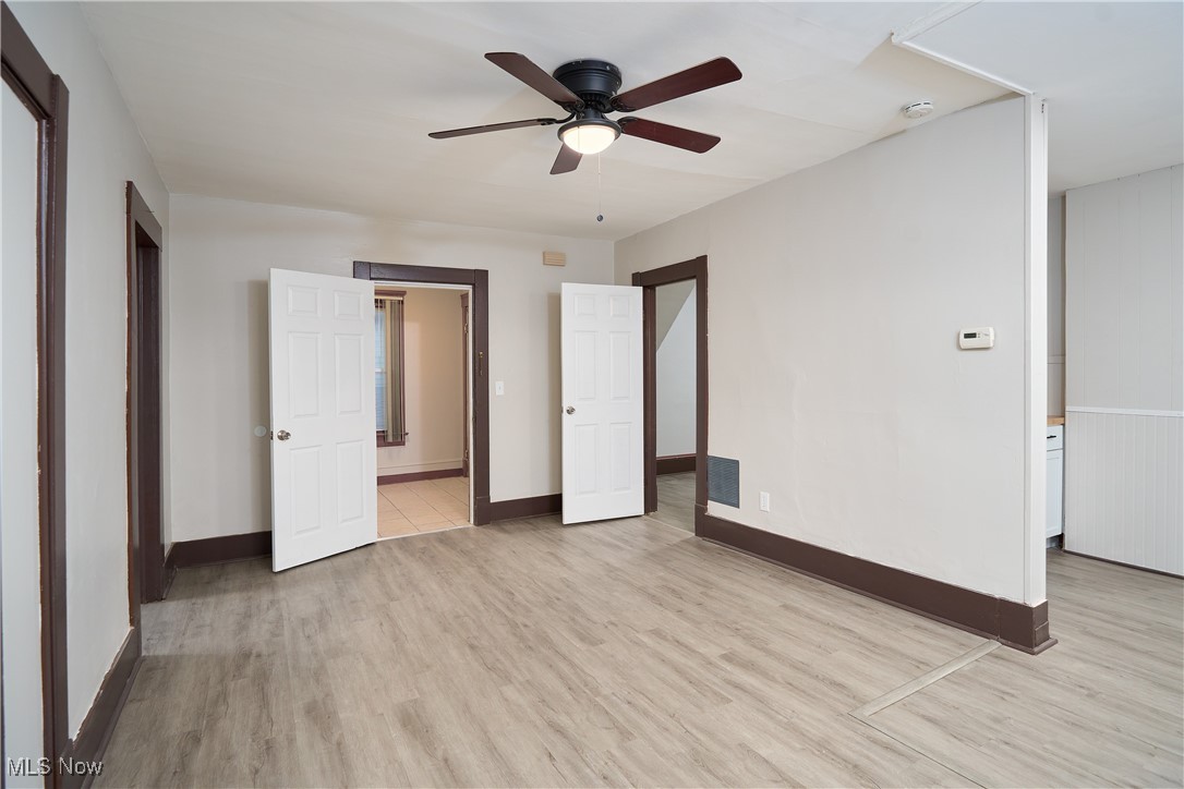 5432 State Road Parma, OH 44134 - Photo 28 of 47 Unfurnished bedroom featuring light wood-style floors, ensuite bathroom, and a ceiling fan