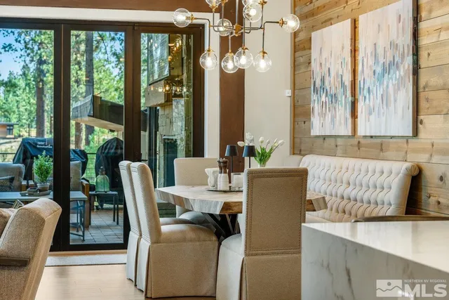 a living room with furniture and large windows