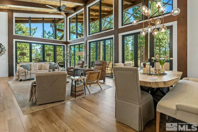 a view of a dining room with furniture large windows and wooden floor