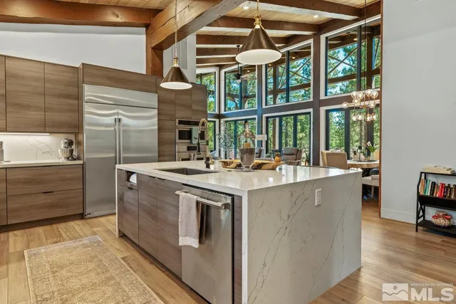 a kitchen with stainless steel appliances granite countertop a stove and a refrigerator