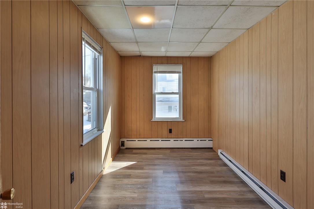 115 East Ruddle Street Coaldale, PA 18218 - Photo 22 of 57 Classic wood paneling and durable vinyl plank flooring define this versatile bonus space.