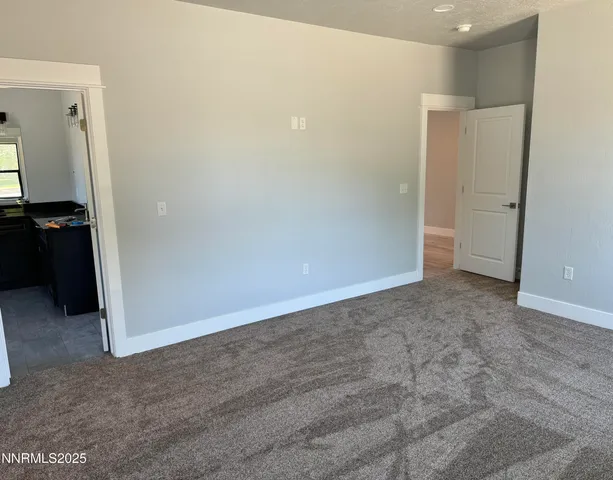 an empty room with closet and wooden door