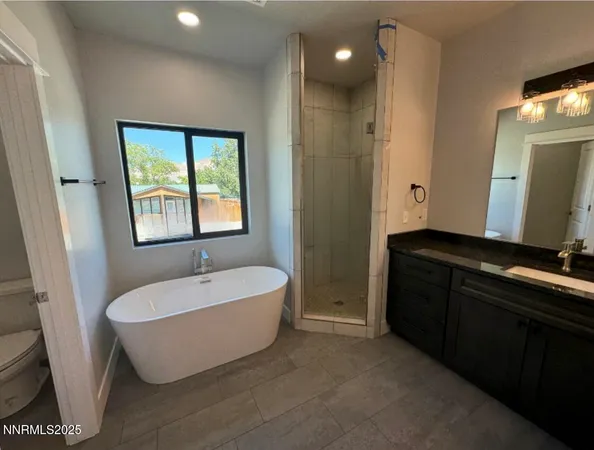 a spacious bathroom with a double vanity sink a mirror and a bathtub