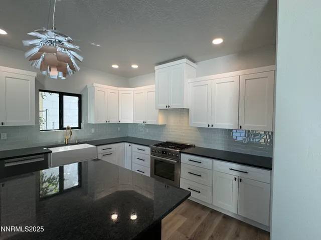 a kitchen with a sink stainless steel appliances and cabinets