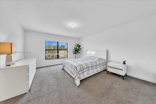 a spacious bedroom with a bed and a couch