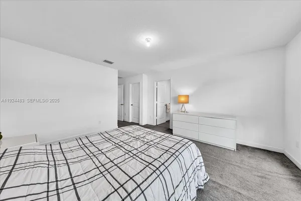 a bedroom with a bed and mirror