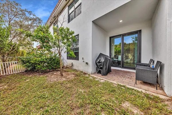 a view of two chairs in the patio
