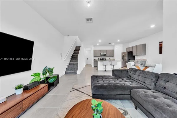 a living room with furniture and a flat screen tv