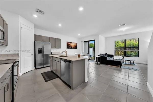 a kitchen with a sink and counter top space