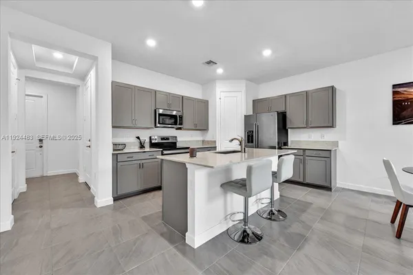 a kitchen with cabinets stainless steel appliances and a counter top space