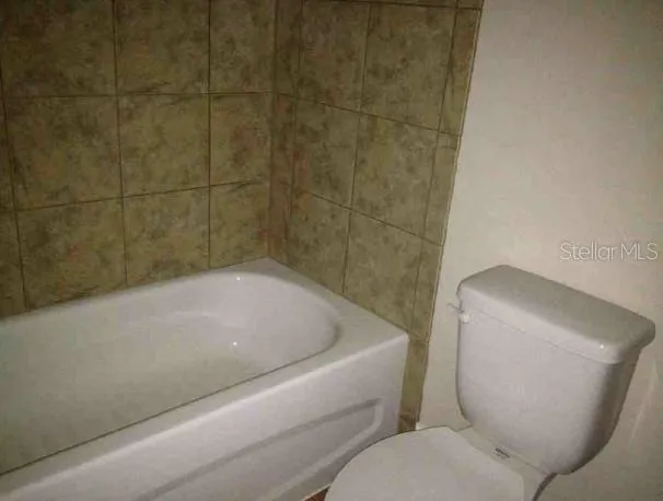 a bathroom with a toilet and bathtub