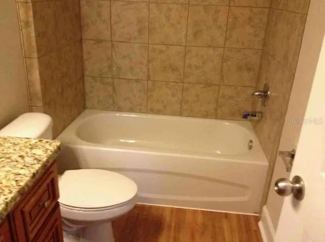 a bathroom with a toilet and a bathtub