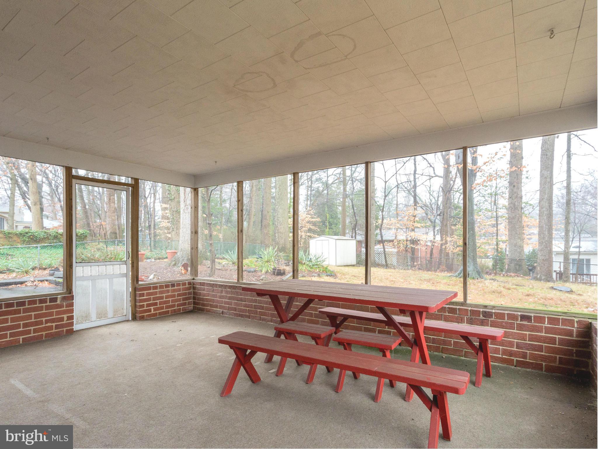 8613 Victoria Road Springfield, VA 22151 - Photo 16 of 21 a living room with furniture and floor to ceiling windows