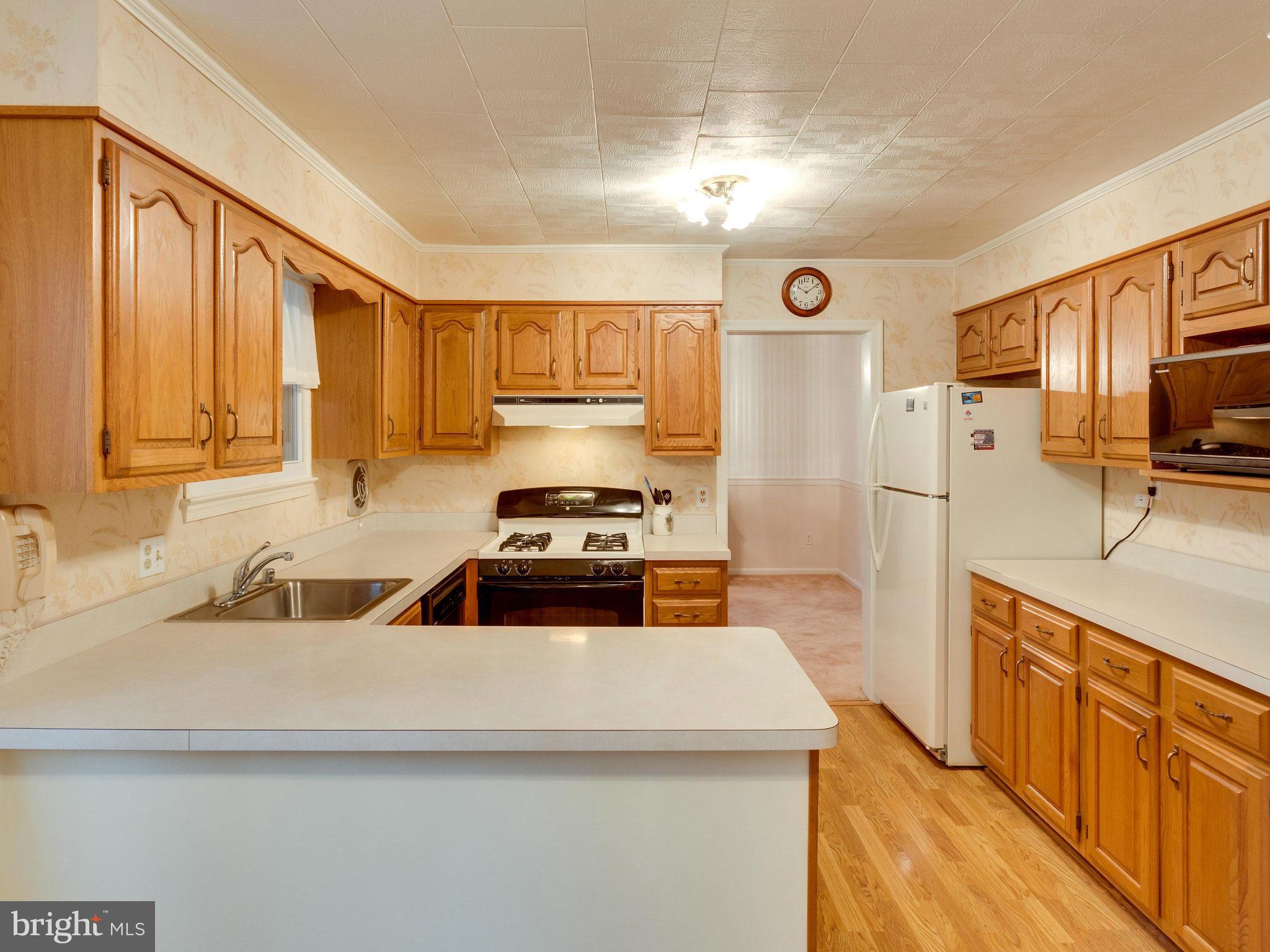 8613 Victoria Road Springfield, VA 22151 - Photo 3 of 21 a kitchen with stainless steel appliances a stove a sink and a refrigerator
